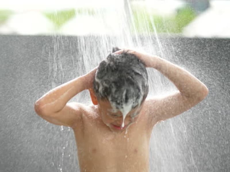 Boy taking a shower